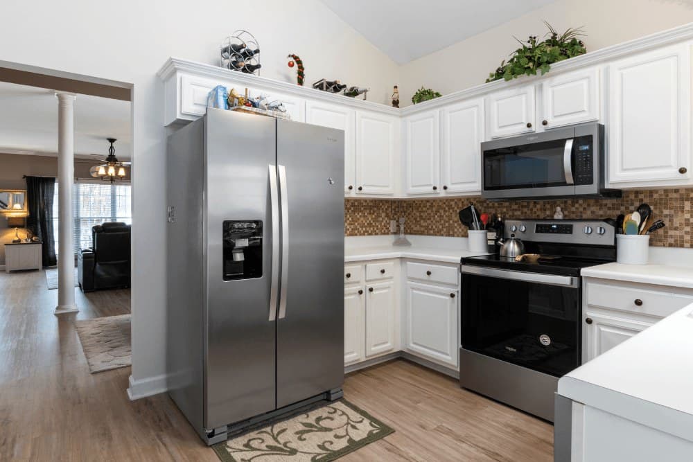 Kitchen with a stainless steel refrigerator, over-the-range microwave and freestanding range, the mix of appliances we repair under one roof